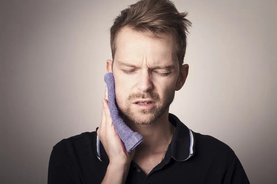 sore jaw and sensitive teeth as a result of tooth grinding