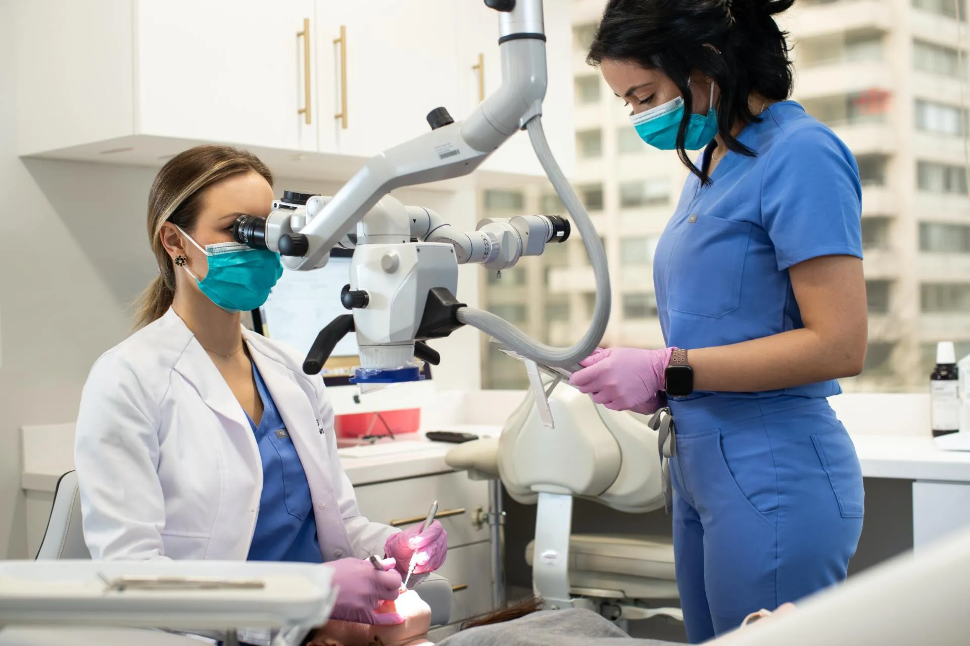 a dentist and her dental assistant